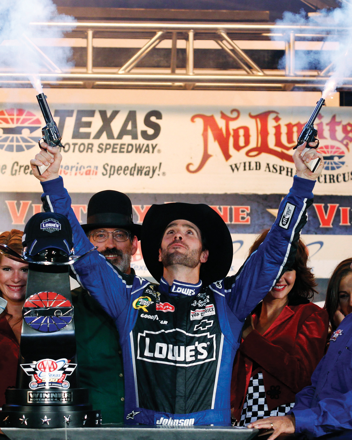 At the Texas Motor Speedway, NASCAR race winners traditionally fire six-shooters into the air. Photo by: Tim Sharp/AP Images