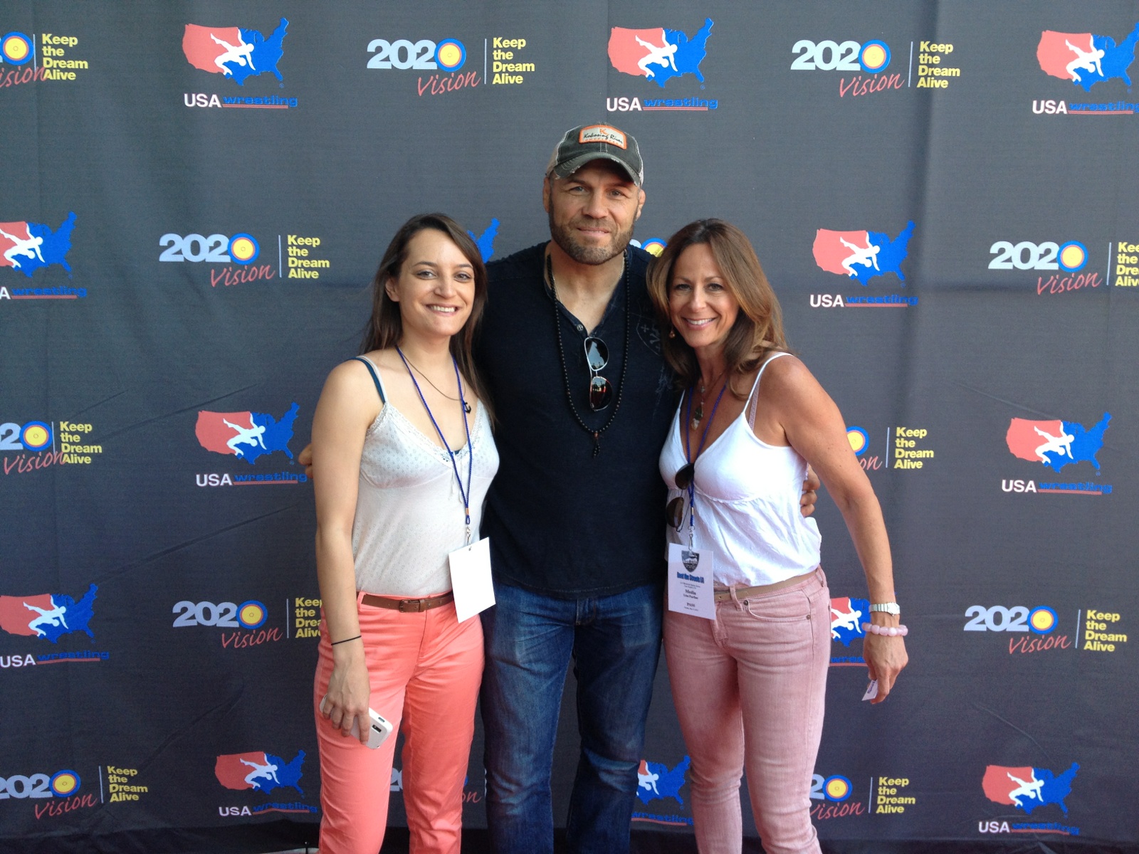 SportsTravel's Nicole Goddeyne and Lisa Furfine with MMA star Randy Couture on United 4 Wrestling's red carpet.