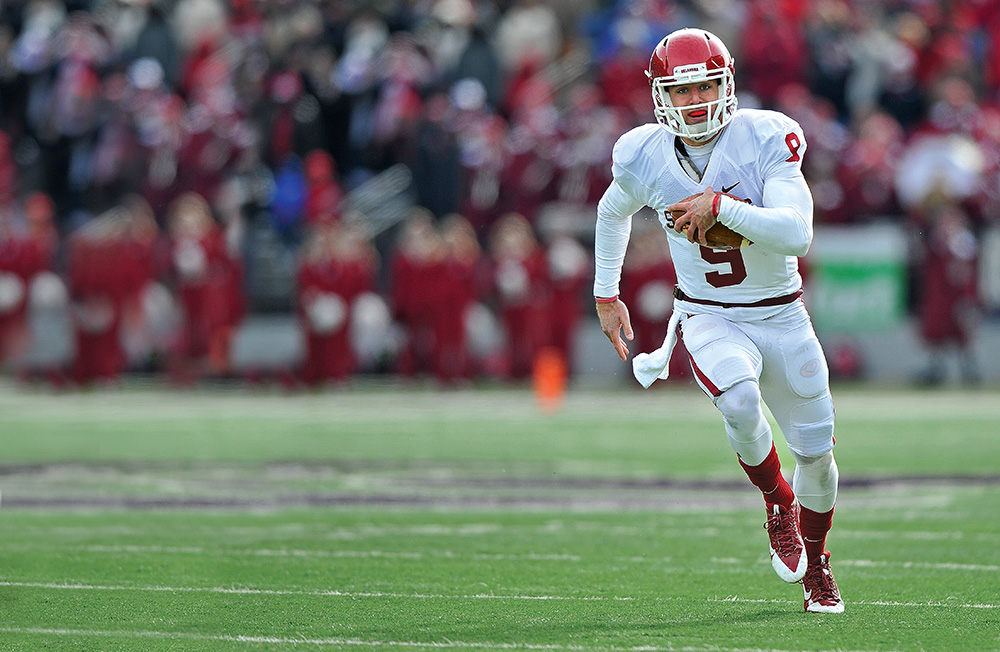 The Oklahoma Sooners, led by quarterback Trevor Knight, are a favorite to earn one of four spots in the new College Football Playoff. Photo by Peter G. Aiken/Getty Images