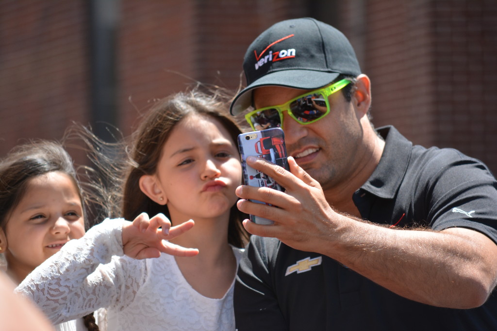 2015 Indy 500 winner Juan Pablo Montoya and his daughter joke around during the parade before the race.