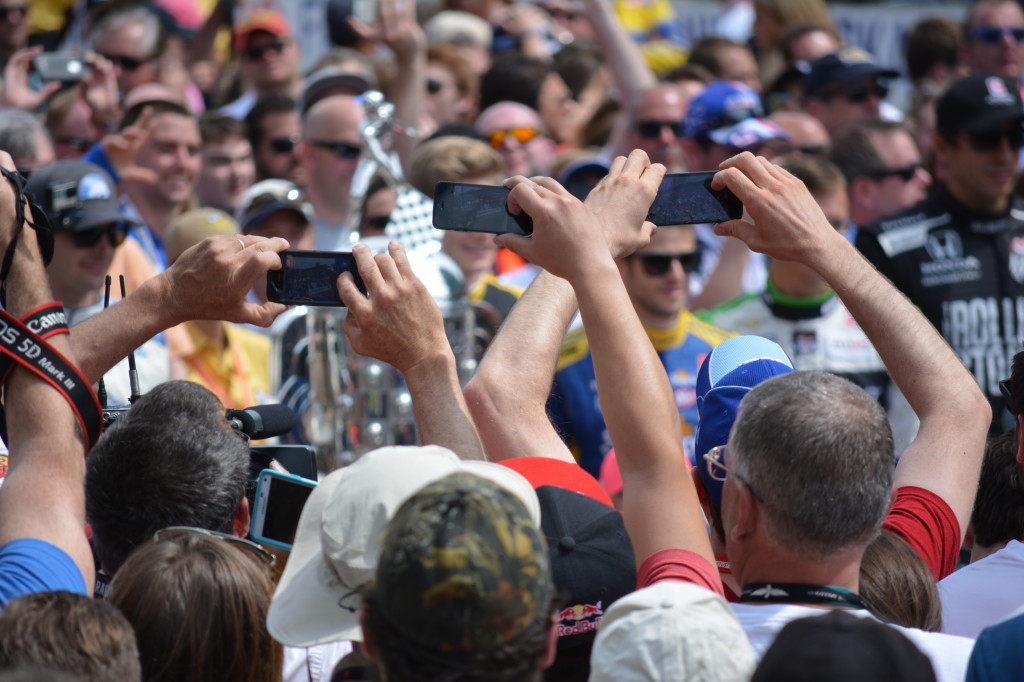 Fans used their phones to capture images of their favorite drivers before the race.