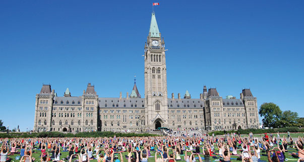 From May to December in Ottawa, Ontario, thousands of residents and visitors have the chance to participate in free yoga sessions outside the Parliament of Canada. Photo courtesy of Ottawa Tourism