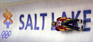 Georg Hackl of Germany speeds past an Olympic logo during a practice run for the men's singles luge at the 2002 Salt Lake City Winter Olympics in Park City, Utah. (AP Photo/Elise Amendola, File)