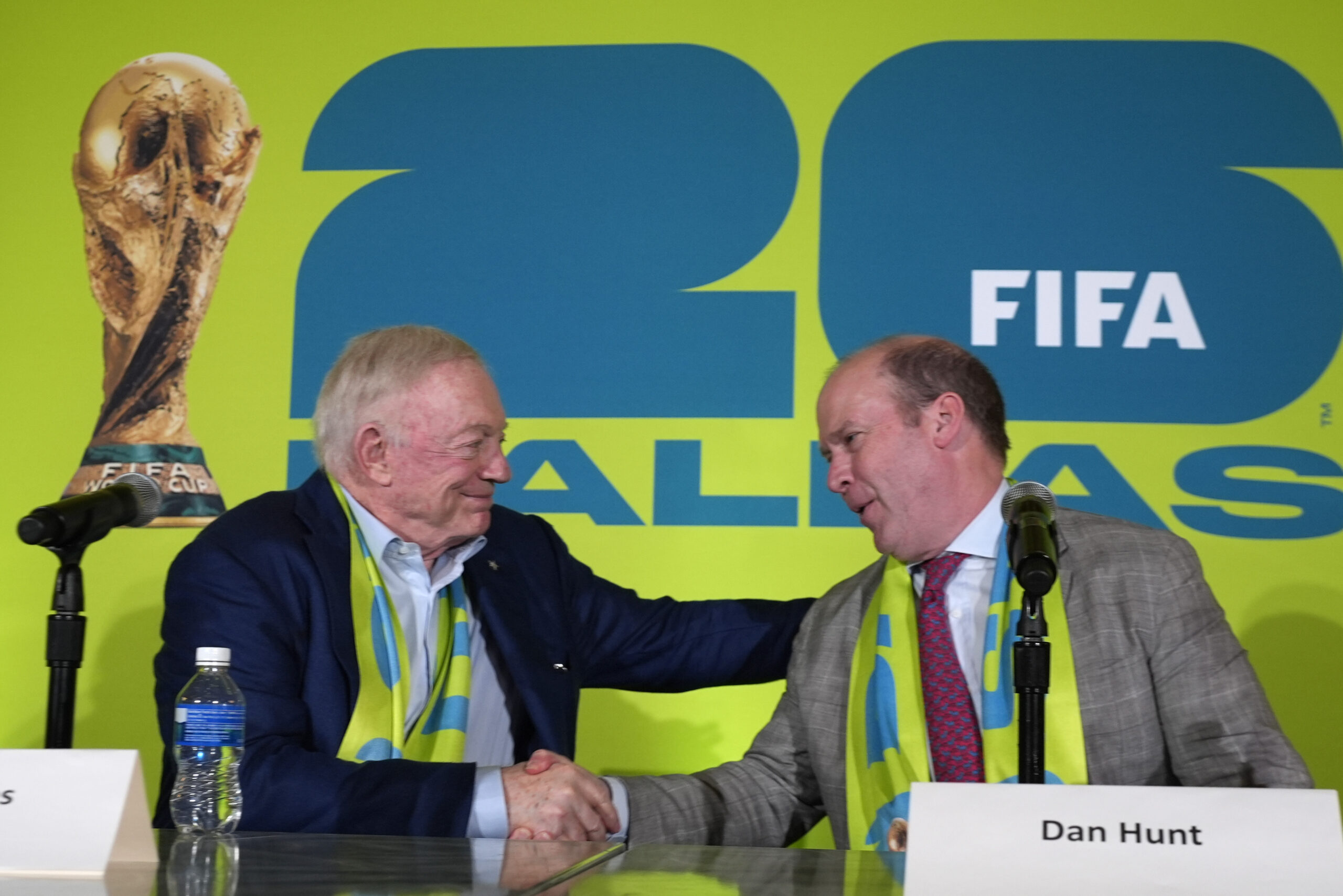 Dallas Cowboys owner Jerry Jones, left, and FC Dallas president Dan Hunt, right, shake hands after the match schedule was revealed for soccer's FIFA World Cup 2026 during an even at AT&T Stadium in Arlington, Texas, Sunday, Feb. 4, 2024. (AP Photo/LM Otero)