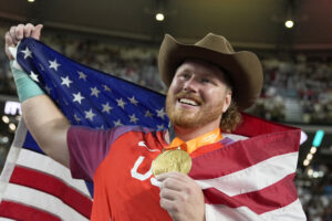 Ryan Crouser of the United States poses after winning the gold medal in the shot put at the 2023 World Athletics Championships in Budapest. Crouser is a fan of World Athletics' plan to pay gold medalists in athletics at the 2024 Olympic Summer Games in Paris. (AP Photo/Matthias Schrader)
