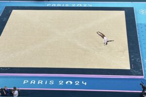 Simone Biles of the United States flies throgh the air during the floor exercise in the women's team competition at the 2024 Olympic Summer Games in Paris on Tuesday. Photo by Matt Traub/SportsTravel