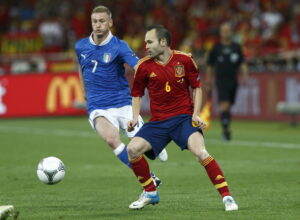Spanish midfielder Andres Iniesta controls the ball during the Euro 2012 final against Italy. Photo via World Cup 2030 Bid Committe and Carmelo Rubio