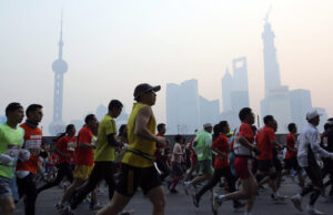 Participants run on the Bund, one of the most popular tourist destinations in town, during the Shanghai International Marathon in 2013. (AP Photo/Eugene Hoshiko)