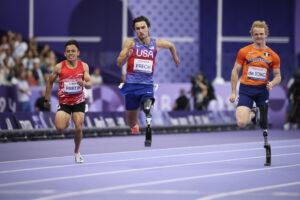 Ezra Frech from the U.S. leads the men's 100 m. T63 competition at the 2024 Paralympics on his way to a gold medal in Paris. (AP Photo/Thomas Padilla)