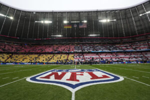 The 50 yard line before Sunday's game between the Carolina Panthers and the New York Giants at Allianz Arena in Munich showcases the NFL's international reach. (AP Photo/Steve Luciano)